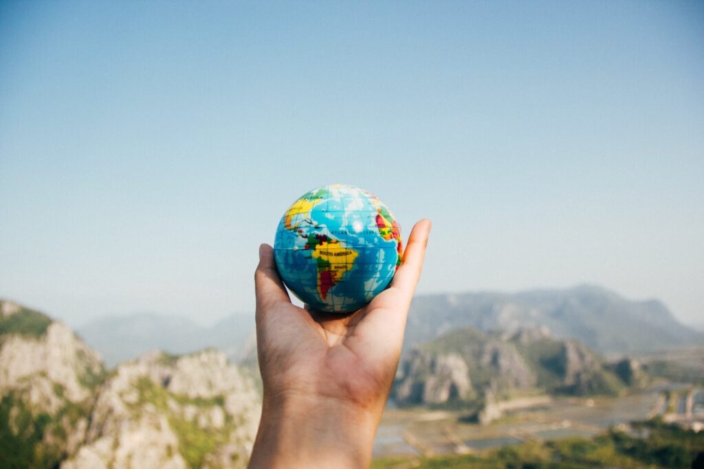 Person holding a world globe
