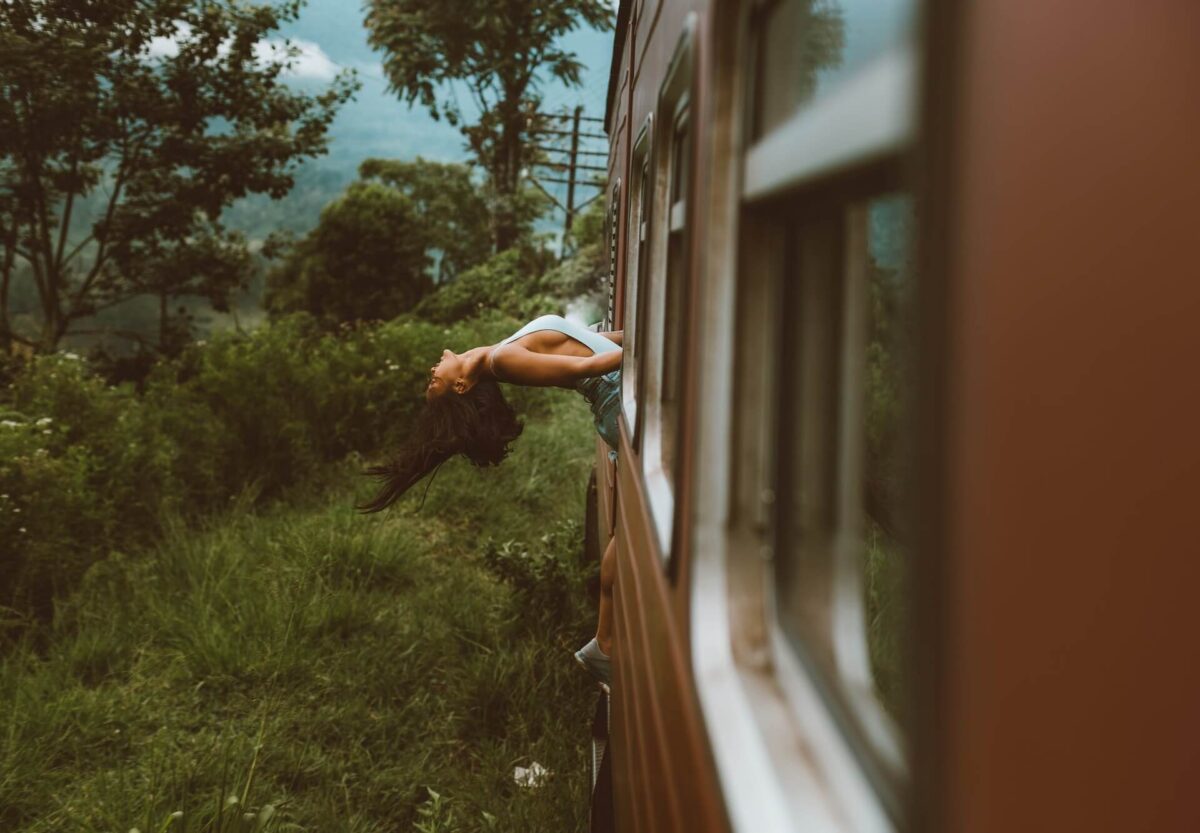 A woman leaning back in a train
