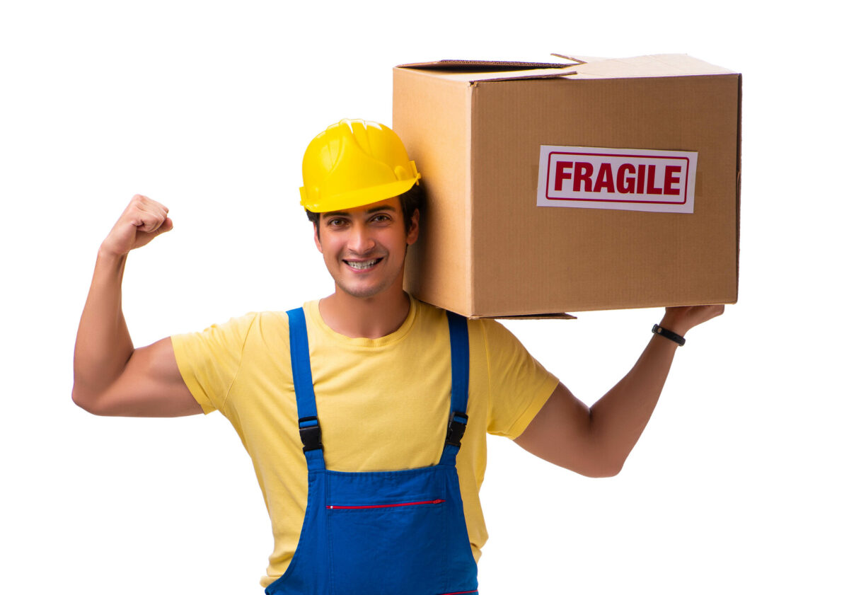 A professional mover holding a box labeled fragile