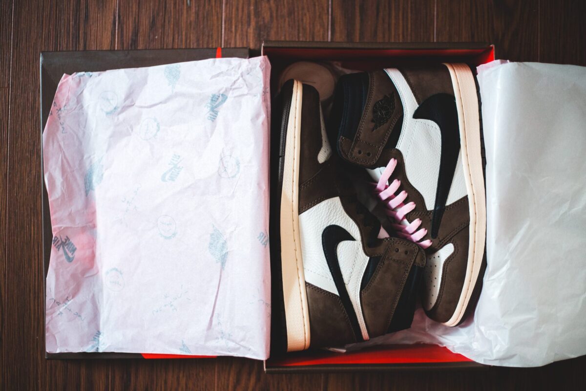 Sneakers over wrapping paper in the original box