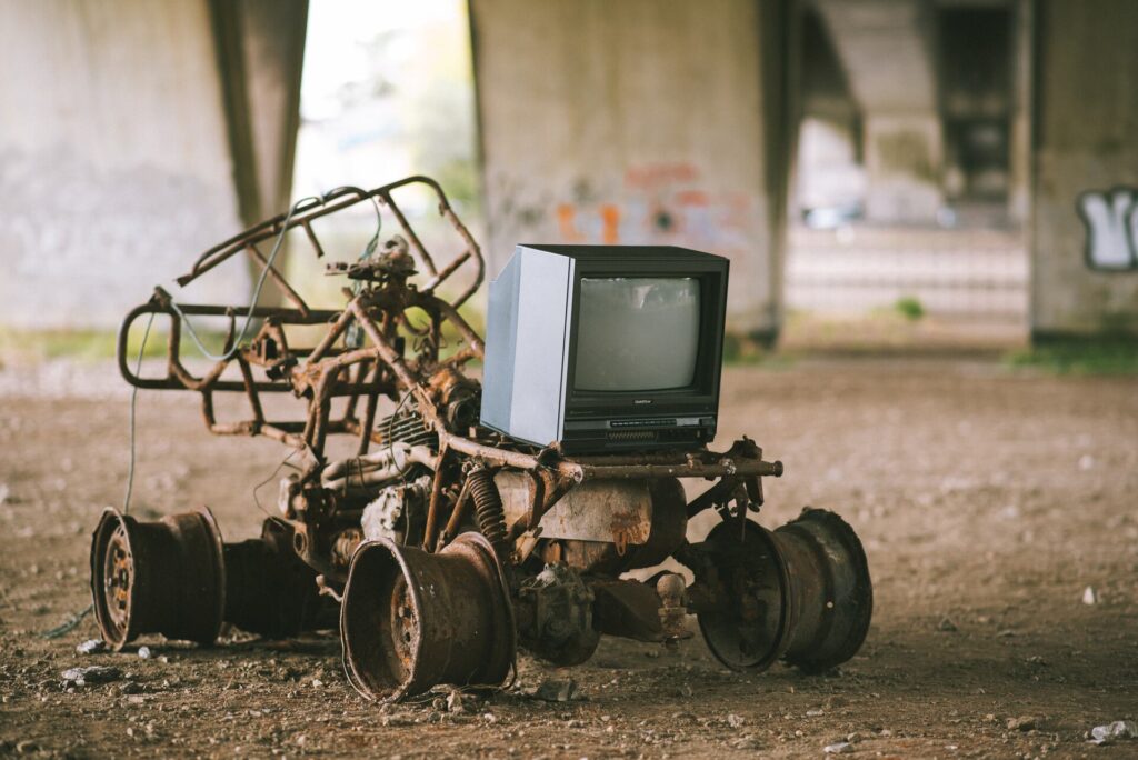 Old television on rusty metal structure