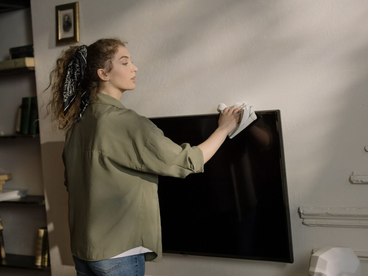 woman-standing-near-black-flat-screen-tv