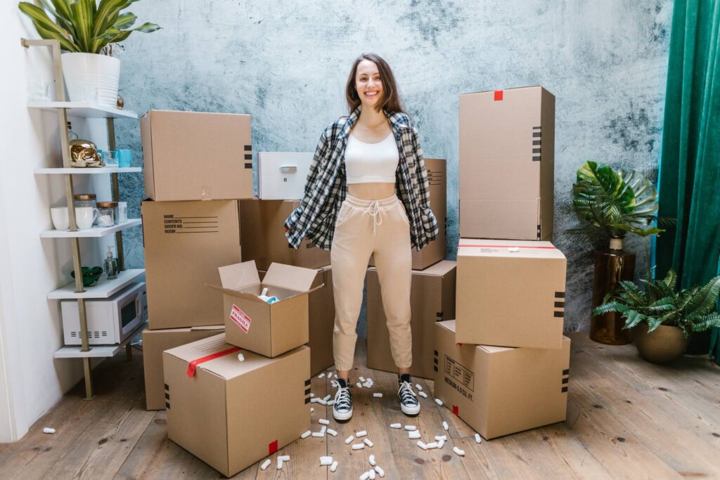 Woman surrounded by boxes and plants