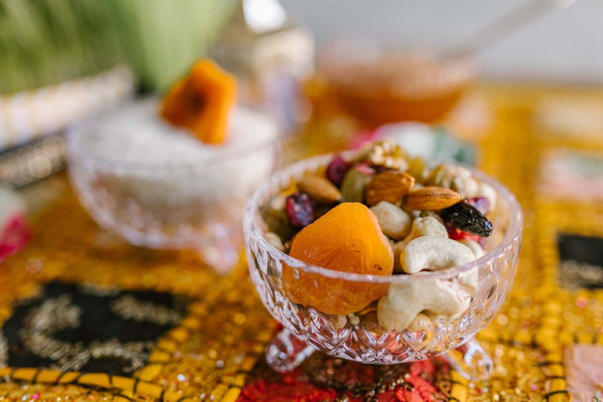 Decorative bowl with legs filled with dried fruits