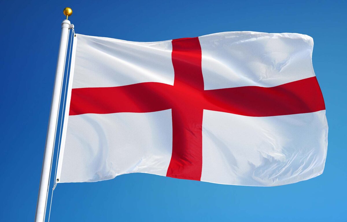 England flag waving against clean blue sky, close up, isolated with clipping path mask alpha channel transparency