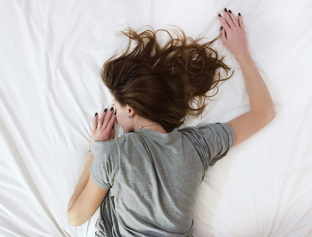 Woman lying face down on the bed