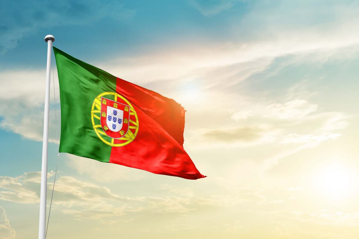 Portugal national flag cloth fabric waving on the sky