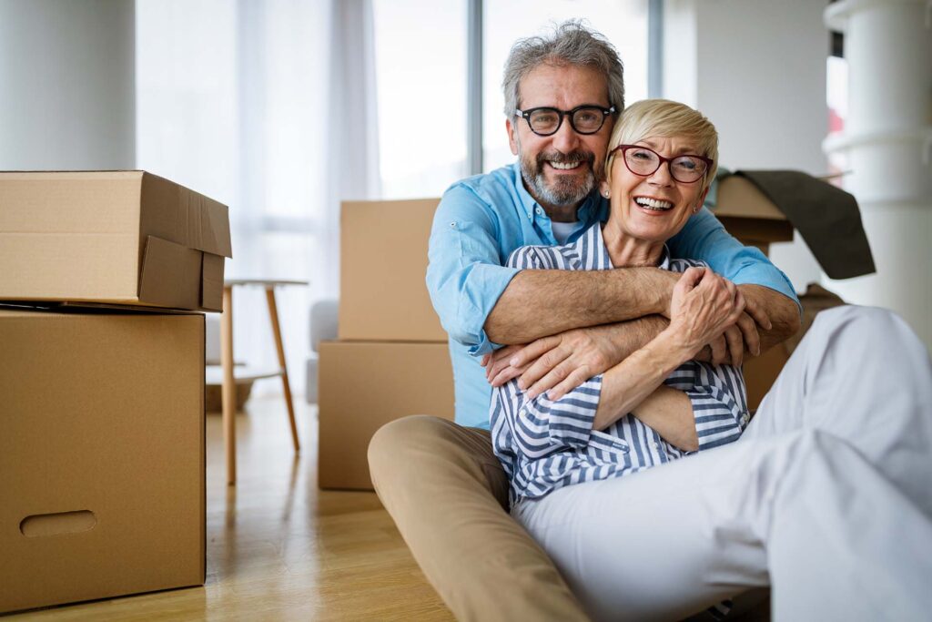 Portrait of happy smiling senior couple in love moving in new home