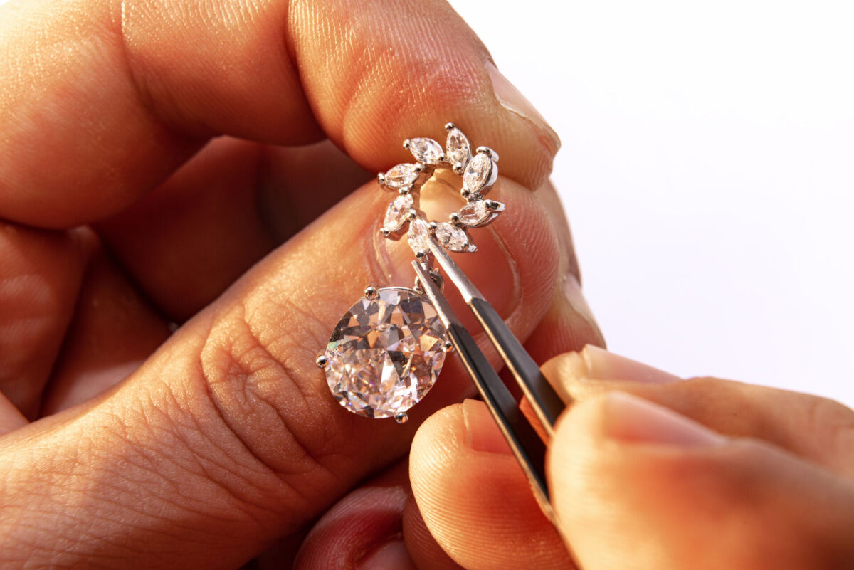 Person checking the diamond on the ring